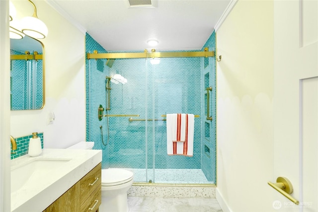 bathroom with toilet, vanity, ornamental molding, and a stall shower