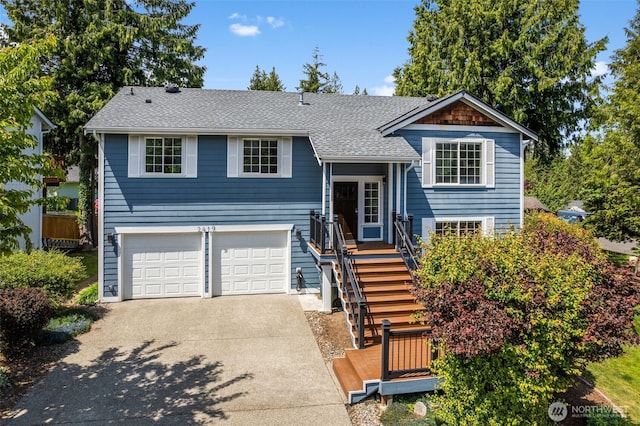 2419 53rd Street Ct NW, Gig Harbor, WA 98335 - raised ranch with driveway, a garage, and roof with shingles