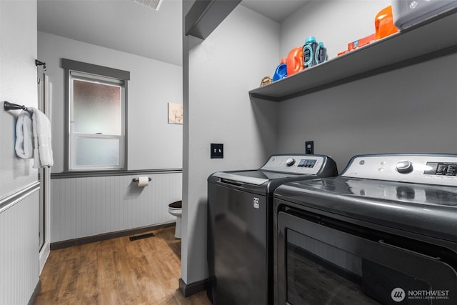 2419 53rd Street Ct NW, Gig Harbor, WA 98335 - laundry area with washing machine and clothes dryer, dark wood-style floors, a wainscoted wall, and baseboards