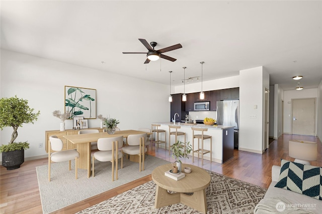 2960 Eastlake Ave E Unit 307, Seattle, WA 98102 - living area featuring wood finished floors, a ceiling fan, and baseboards