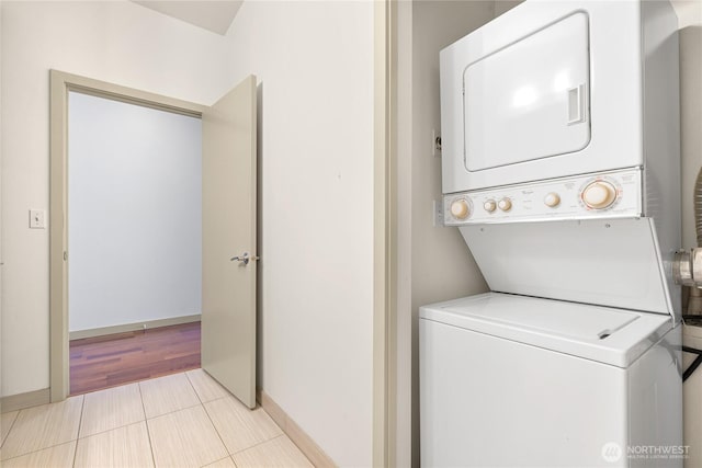 2960 Eastlake Ave E Unit 307, Seattle, WA 98102 - laundry room with stacked washer / dryer, baseboards, and tile patterned floors