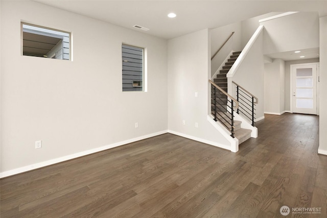 unfurnished room featuring stairway, dark wood-style floors, recessed lighting, and baseboards