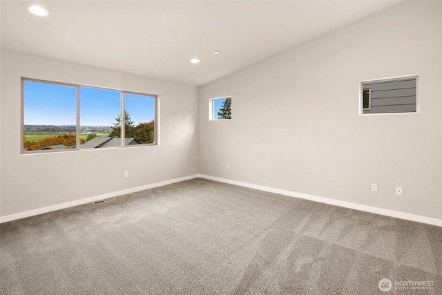 carpeted empty room featuring baseboards, recessed lighting, and lofted ceiling