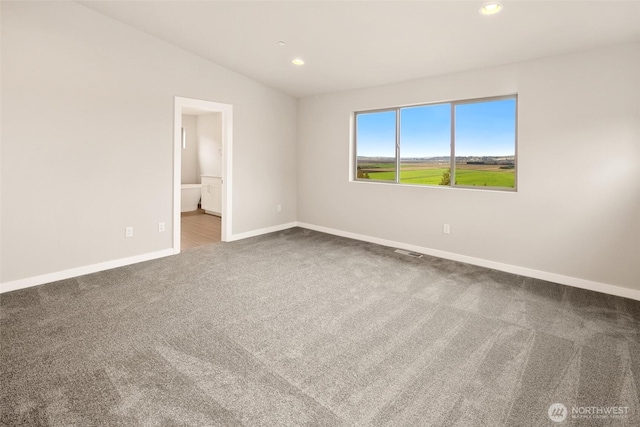 carpeted spare room featuring baseboards, recessed lighting, and lofted ceiling