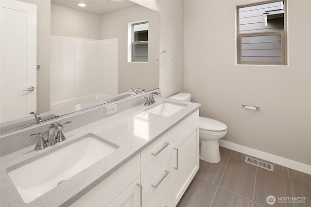 full bathroom with toilet, baseboards, a shower, double vanity, and tile patterned flooring