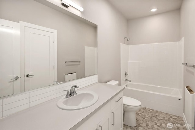 full bathroom with toilet,  shower combination, vanity, and recessed lighting