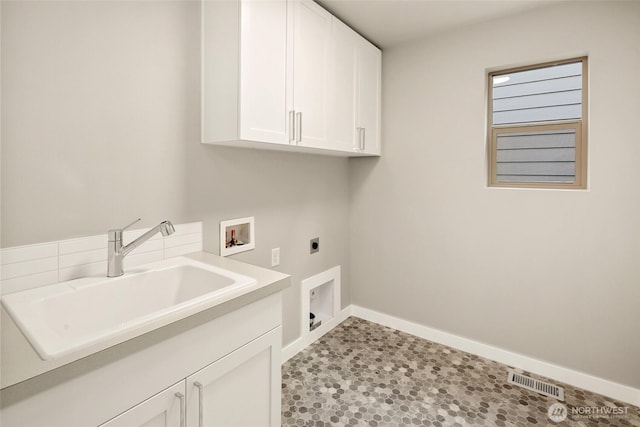 laundry area with electric dryer hookup, cabinet space, hookup for a washing machine, and baseboards