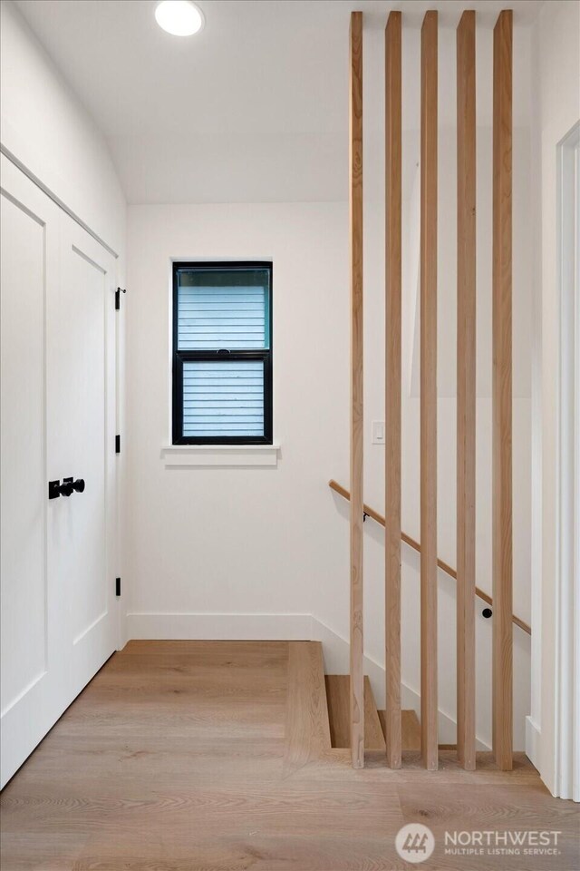 unfurnished bedroom with light wood-type flooring and baseboards