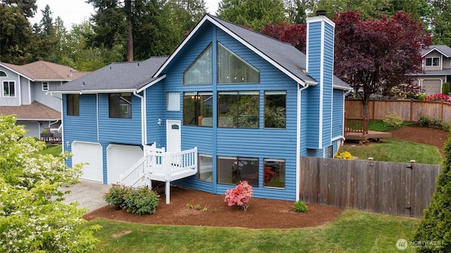 18323 23rd Dr SE, Bothell, WA 98012 - back of house with fence, a chimney, a garage, and asphalt driveway
