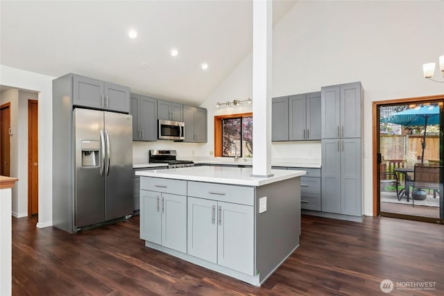 18323 23rd Dr SE, Bothell, WA 98012 - kitchen with stainless steel appliances, gray cabinetry, high vaulted ceiling, light countertops, and a kitchen island