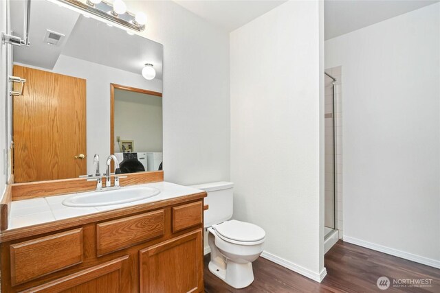 18323 23rd Dr SE, Bothell, WA 98012 - full bathroom with wood finished floors, toilet, connected bathroom, a shower with door, and vanity