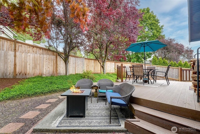 18323 23rd Dr SE, Bothell, WA 98012 - wooden deck featuring a fire pit, outdoor dining space, and a fenced backyard