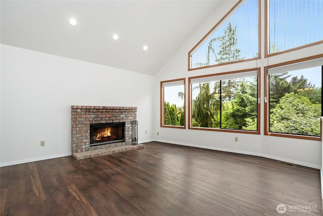 18323 23rd Dr SE, Bothell, WA 98012 - unfurnished living room with high vaulted ceiling, dark wood finished floors, a fireplace, baseboards, and recessed lighting