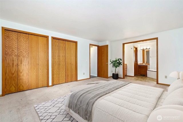 18323 23rd Dr SE, Bothell, WA 98012 - bedroom with multiple closets, light colored carpet, baseboards, and ensuite bath