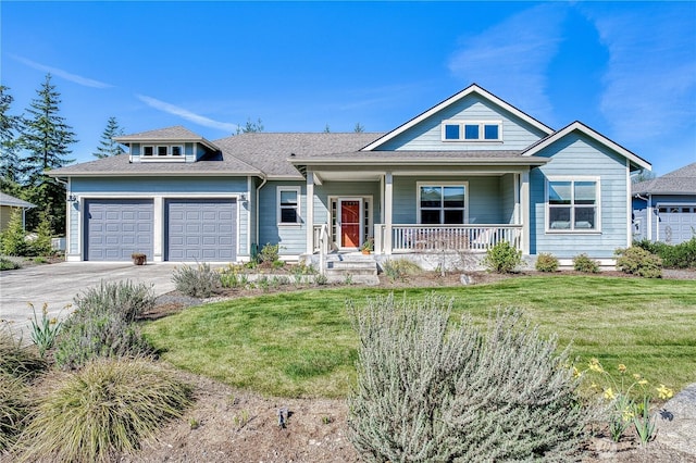 view of front of house with a porch, an attached garage, a front yard, and concrete driveway