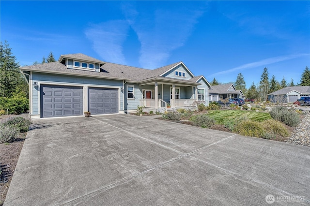 view of front of house featuring covered porch, an attached garage, and concrete driveway