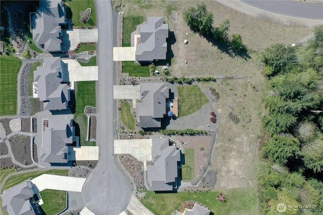 aerial view of property and surrounding area with nearby suburban area