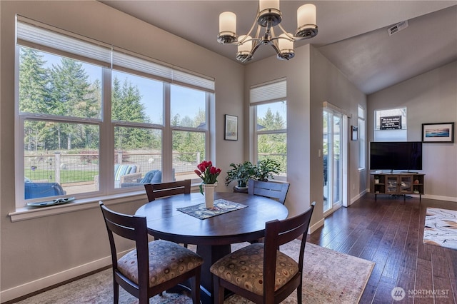 dining area featuring plenty of natural light, baseboards, a chandelier, hardwood / wood-style floors, and lofted ceiling
