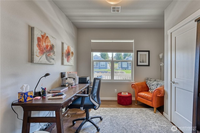 office with wood finished floors and baseboards