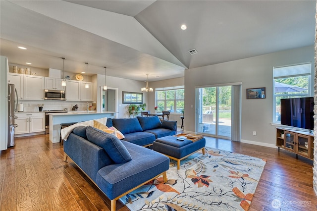 living room with a chandelier, wood-type flooring, vaulted ceiling, recessed lighting, and baseboards