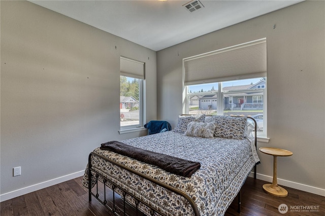 bedroom with baseboards and wood finished floors