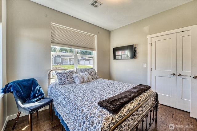 bedroom featuring wood finished floors and a closet