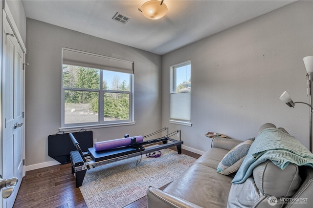 living area with baseboards and wood finished floors