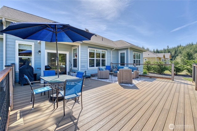 wooden deck with an outdoor hangout area and outdoor dining area
