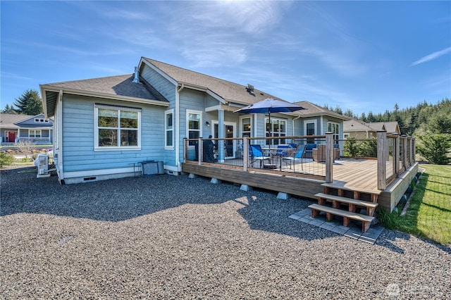 rear view of property with a deck, a shingled roof, and crawl space