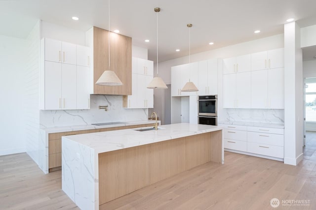 6773 Rd E.2 NE, Moses Lake, WA 98837 - kitchen with modern cabinets, light wood-type flooring, backsplash, black electric stovetop, and recessed lighting