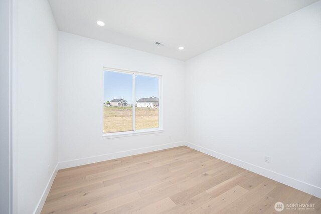 6773 Rd E.2 NE, Moses Lake, WA 98837 - spare room featuring baseboards, light wood-style floors, and recessed lighting