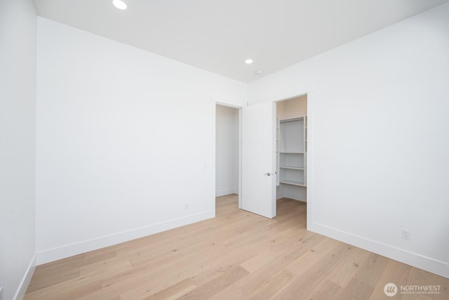 6773 Rd E.2 NE, Moses Lake, WA 98837 - unfurnished bedroom with baseboards, light wood-style flooring, recessed lighting, and a spacious closet