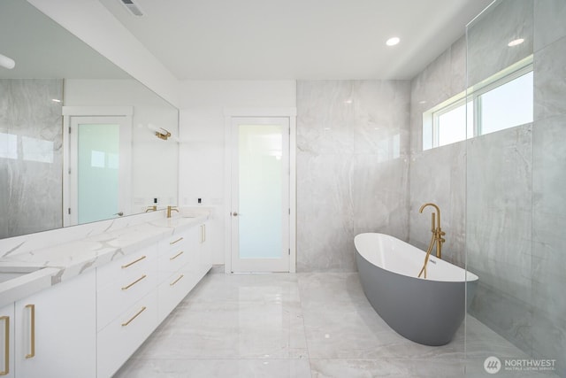 6773 Rd E.2 NE, Moses Lake, WA 98837 - bathroom with marble tiled flooring, a soaking tub, and double vanity