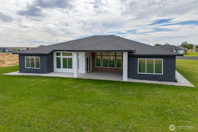 6773 Rd E.2 NE, Moses Lake, WA 98837 - rear view of house featuring a patio, roof with shingles, and a yard