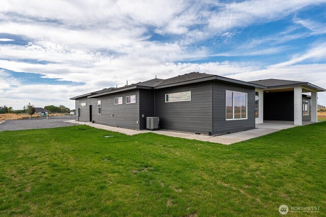 6773 Rd E.2 NE, Moses Lake, WA 98837 - rear view of property featuring a patio area, central air condition unit, and a lawn