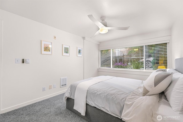 carpeted bedroom featuring baseboards and ceiling fan