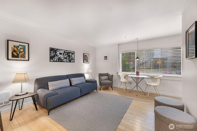 living room featuring hardwood / wood-style floors and baseboards