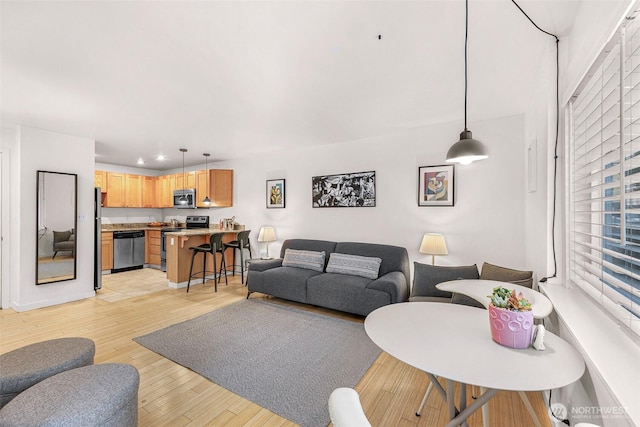 living room featuring light wood-type flooring and recessed lighting