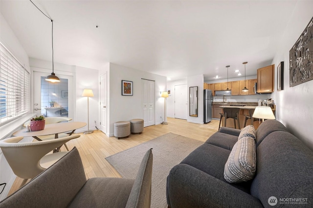 living room with light wood-style floors and baseboards