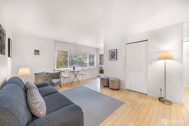 living area with wood finished floors and baseboards
