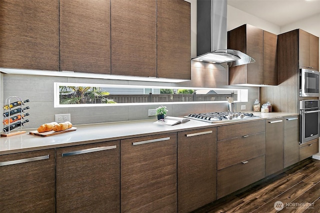 30429 121st Pl SE, Auburn, WA 98092 - kitchen with stainless steel appliances, wall chimney exhaust hood, dark wood-type flooring, light countertops, and dark brown cabinetry
