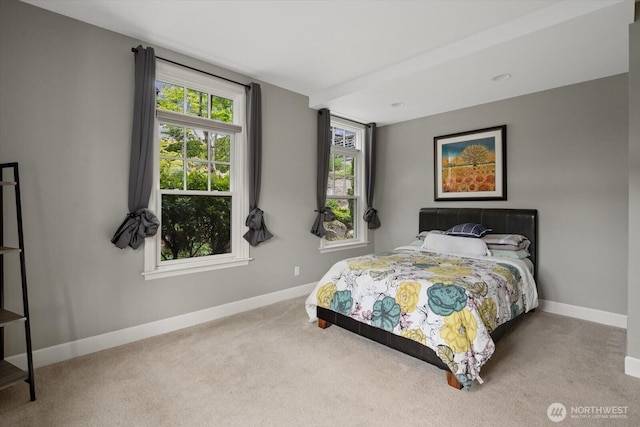 carpeted bedroom with baseboards
