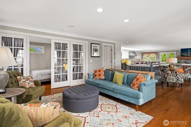 living area with wood finished floors, crown molding, french doors, and recessed lighting