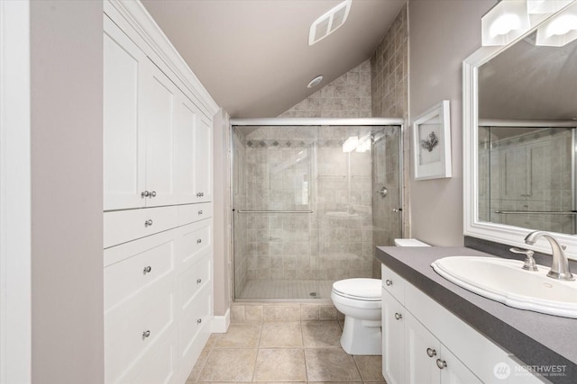 full bathroom with vaulted ceiling, a shower stall, toilet, tile patterned floors, and vanity