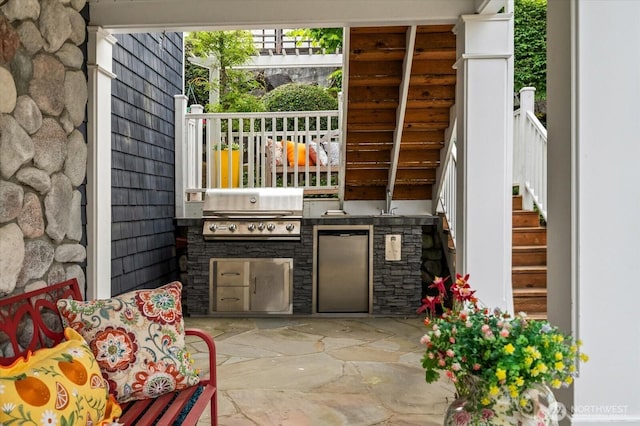 view of patio / terrace featuring a grill, an outdoor kitchen, and stairway