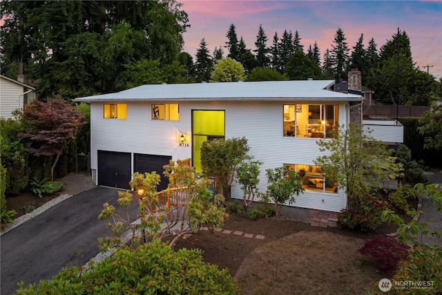 8716 Main St, Edmonds, WA 98026 - view of front of property featuring a garage, asphalt driveway, and a chimney