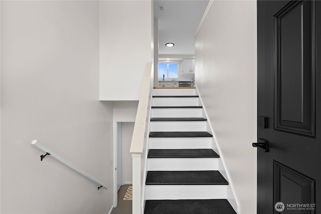 8716 Main St, Edmonds, WA 98026 - staircase featuring recessed lighting and baseboards