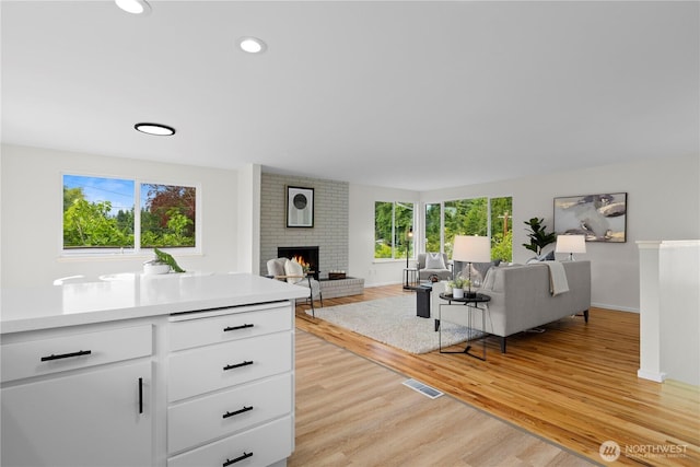 8716 Main St, Edmonds, WA 98026 - living room with a fireplace, light wood-style flooring, and recessed lighting