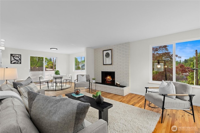 8716 Main St, Edmonds, WA 98026 - living room with a brick fireplace and light wood finished floors