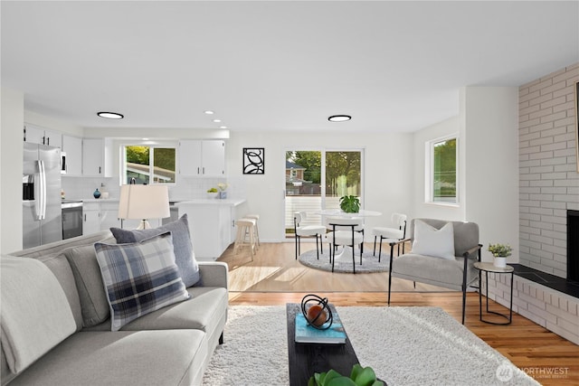 8716 Main St, Edmonds, WA 98026 - living room with light wood-style flooring, a fireplace, and recessed lighting
